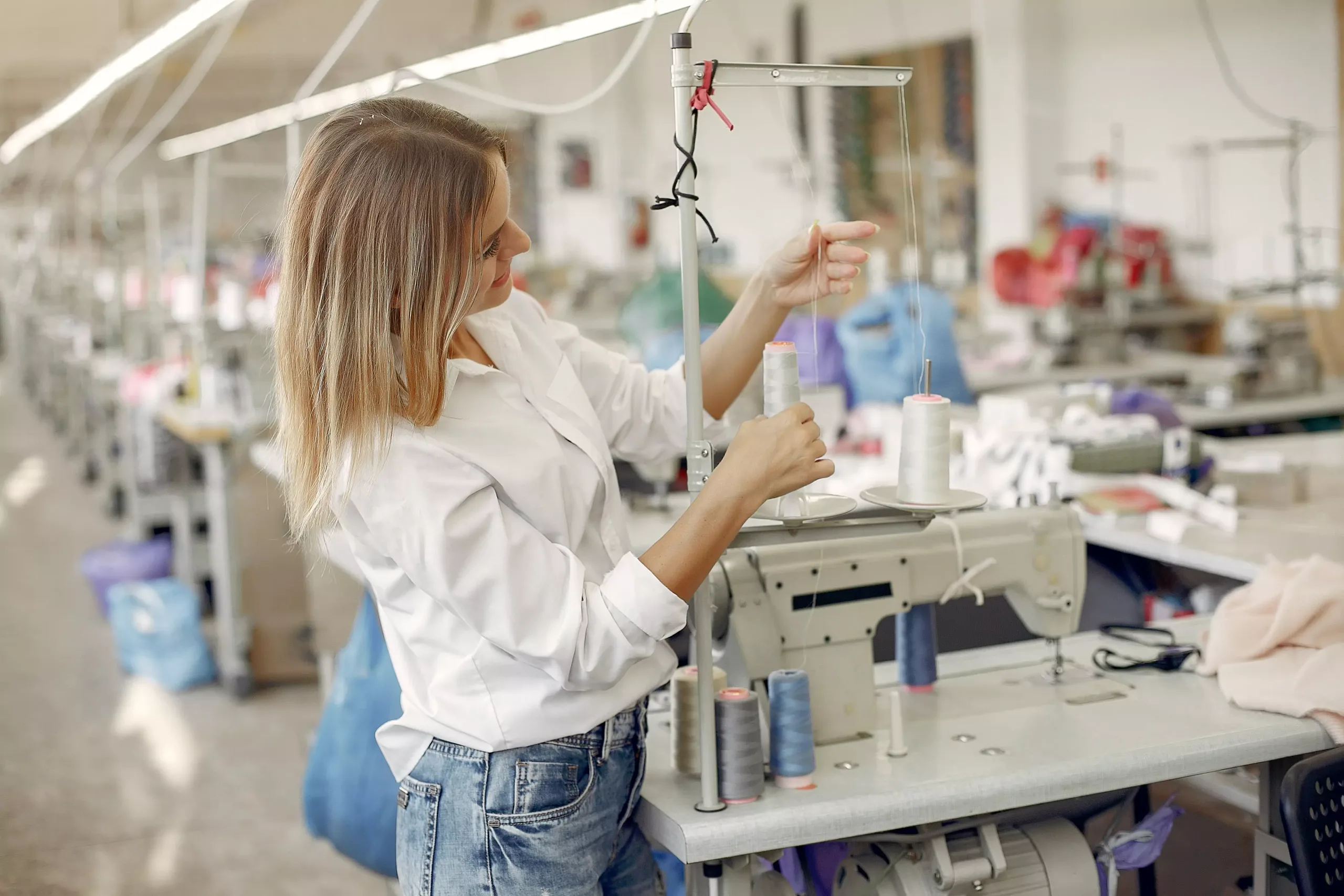 woman standing clothing factory with thread Best China Clothing Factory, One-Stop OEM Solution